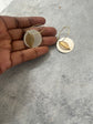 Silver disc and brass leaf in a hoop