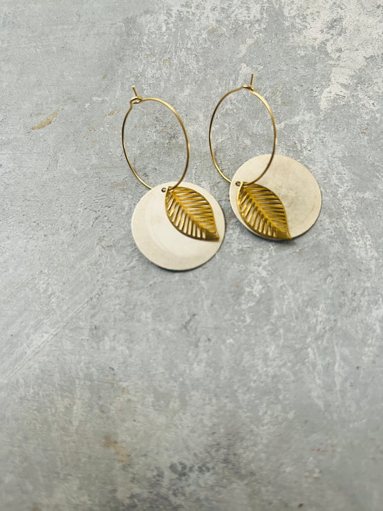 Silver disc and brass leaf in a hoop